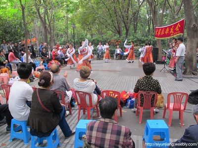 People watching a public dance performance in a park