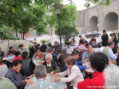 A busy outdoor gathering with people playing games