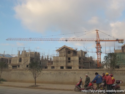 Construction cranes over a residential building site